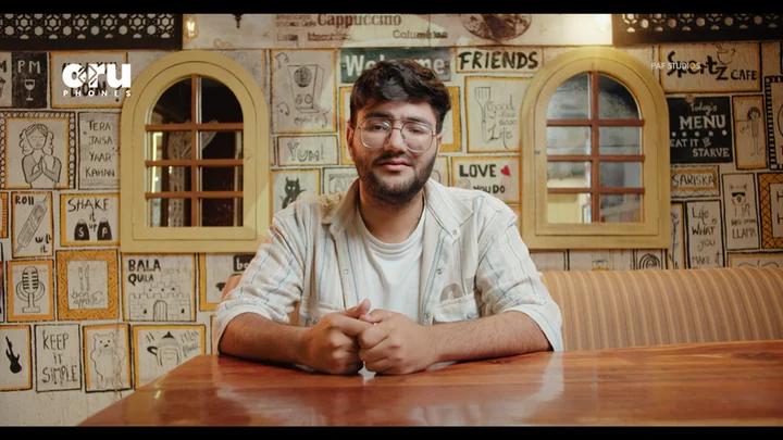 Frame from the ORU Phones ad film The Separation, a man seated in a cafe