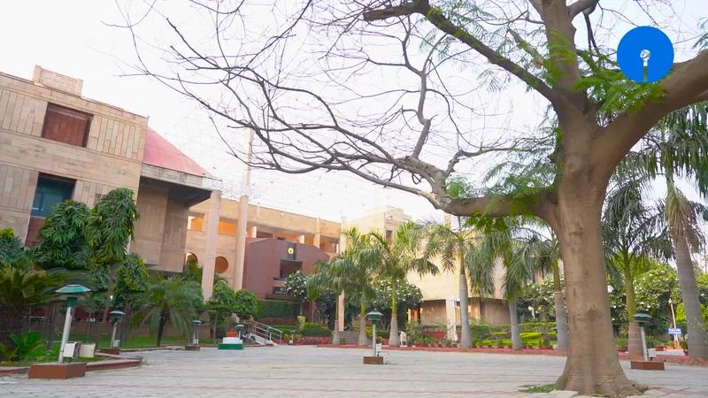 Academy buildings framed by mature trees on the campus grounds