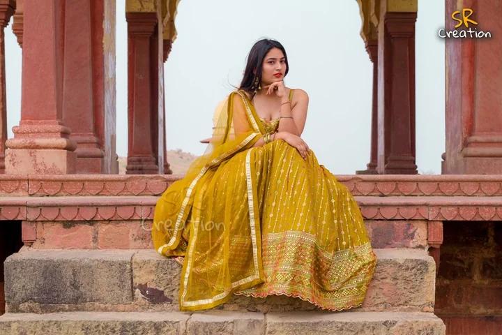 Model in a yellow lehenga photographed at a heritage location for SR Creations