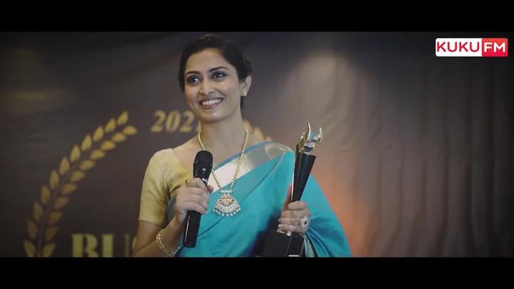 Presenter holding an award on the KUKU FM promotional shoot